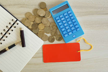 coins with note book and calculator on the table. Business conceptの写真素材