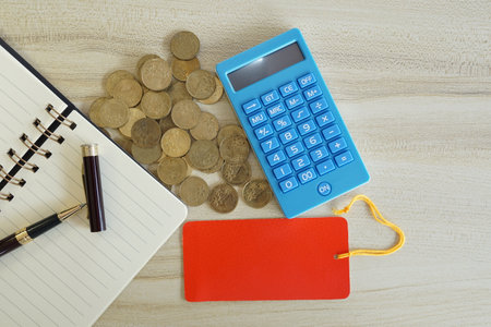coins with note book and calculator on the table. Business conceptの写真素材