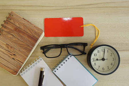 eyeglass and note book on the tableの写真素材
