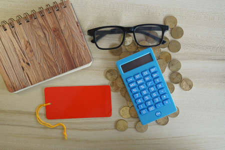 coins with note book and calculator on the table. Business conceptの写真素材