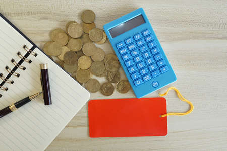 coins with note book and calculator on the table. Business conceptの写真素材