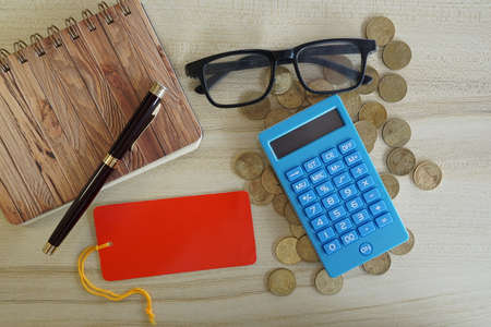 coins with note book and calculator on the table. Business conceptの写真素材