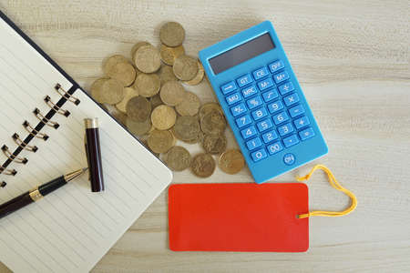 coins with note book and calculator on the table. Business conceptの写真素材