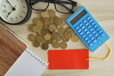coins with note book and calculator on the table. Business conceptの写真素材