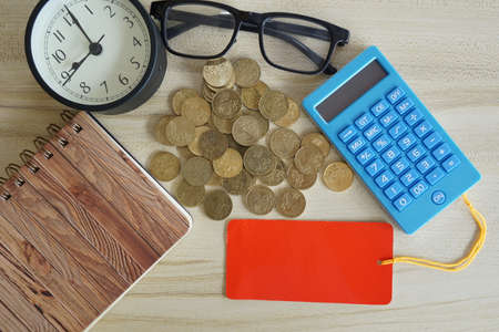 coins with note book and calculator on the table. Business conceptの写真素材