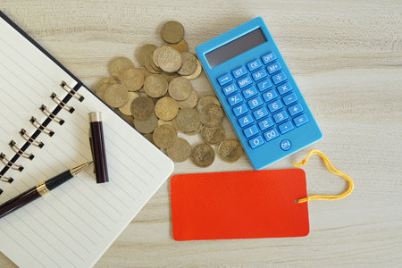 coins with note book and calculator on the table. Business conceptの写真素材