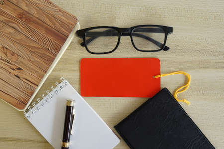 eyeglass, calculator and note book on the tableの写真素材
