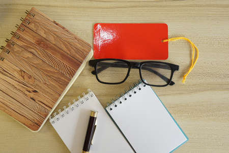 eyeglass, calculator and note book on the tableの写真素材
