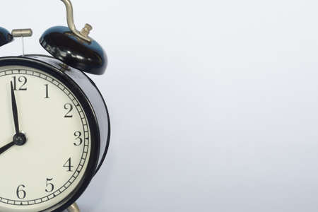 alarm clock and book on the tableの写真素材