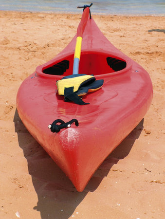 red plastic canoe on a beachの写真素材