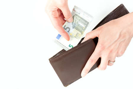 Hands of woman inserting 5 euro in the walletの写真素材