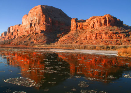 Red rock reflections on the Colorado River with Blue skysの写真素材