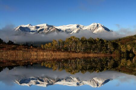 High mountain lake in the fall showing autumn colors reflected in the water Americanaの写真素材