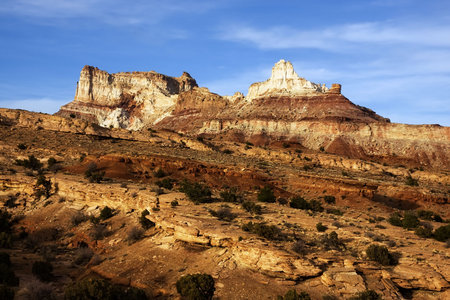 View of the red rock formations in San Rafael Swell with blue sky’s and clouds