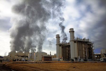 Power pland emitting smoke with cloudy sky's