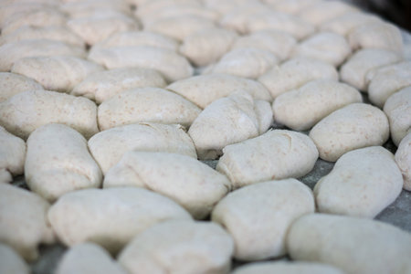 Freshly made bread dough on a tray shot at a local bakery factory.