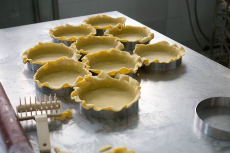 Pie Crusts on a stainless steel prep table at a local pastry and bakery factory.の写真素材