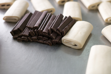 Pile of long baking chocolate for rolling pastries.の写真素材
