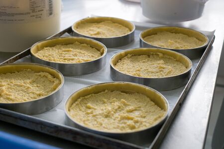 Pastry chef showing off finished cherry filled pies with cookie crumble topping and graham crackers crust.の写真素材