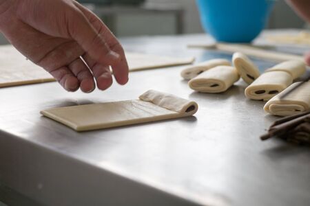 A baker making a chocolate filled pastry.の写真素材