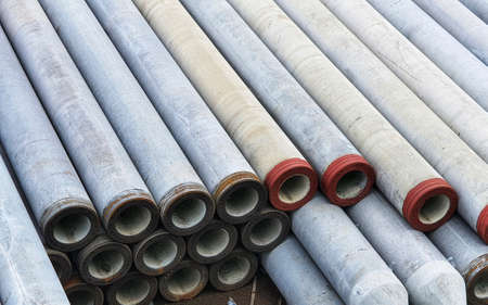Pile of precast concrete spun pile in a construction project stockyard.の写真素材