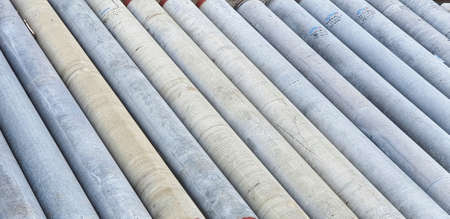 Pile of precast concrete spun pile in a construction project stockyard.の写真素材