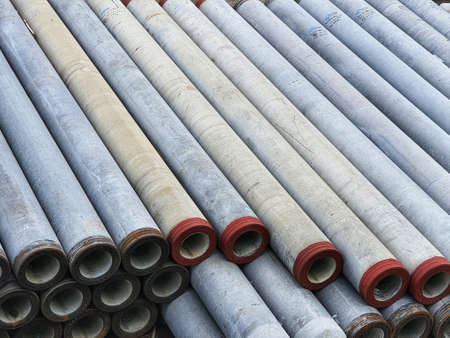 Pile of precast concrete spun pile in a construction project stockyard.の写真素材