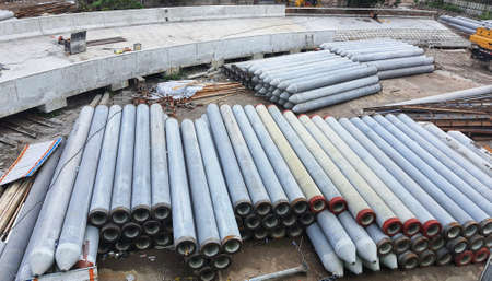 Pile of precast concrete spun pile in a construction project stockyard.の写真素材