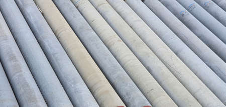 Pile of precast concrete spun pile in a construction project stockyard.の写真素材