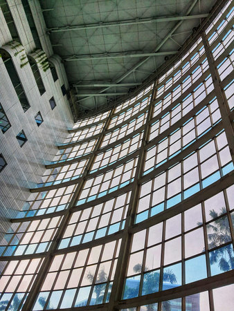 The inside of a tall building, lots of glass and very futuristic.