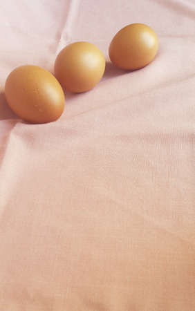 A few eggs on a pink cloth.の写真素材