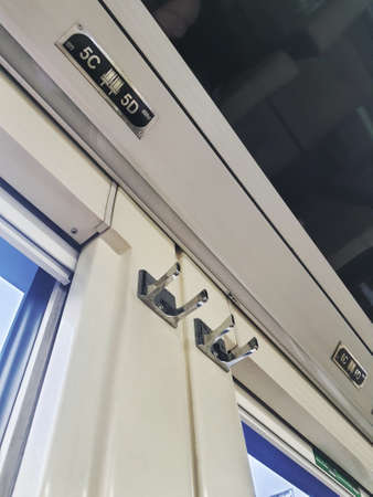 Plastic hangers for trash cans or other items that can be hung above train passenger seats in Indonesia. There are two hangers, right and left.の写真素材