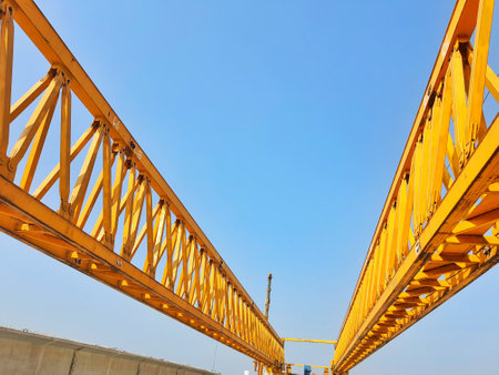 This is the steel structure of a launcher gantry that will be used for erection precast concrete I Girder (PCI Girder) across the river . This yellow gantry launcher comes from China with a capacity of up to 140 tons, with a maximum launch speed of 4 m/min.の写真素材