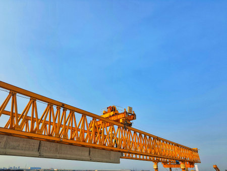 This is the steel structure of a launcher gantry that will be used for erection precast concrete I Girder (PCI Girder) across the river . This yellow gantry launcher comes from China with a capacity of up to 140 tons, with a maximum launch speed of 4 m/min.の写真素材