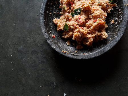 Grated coconut is mixed with spices consisting of garlic, chili, sugar, palm sugar, salt and lime...