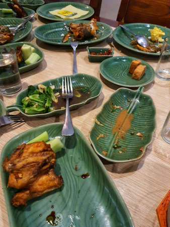 Leftovers on a restaurant table. The plates were empty but there were still side dishes left.の写真素材