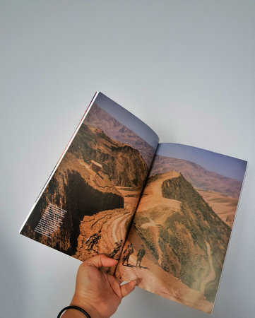 West Java in August 2022. A hand holds the Indonesian version of the National Geographic magazine. National Geographic is the official journal of the National Geographic Society which has provided information about the world and all its contents globally のeditorial素材