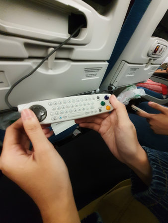 Turkey in July 2022. The interior of the passenger seat of a Turkish Airlines plane that has a touch screen for in-flight entertainment. Which is also equipped with a remote controller that also functions as a game stick.の写真素材