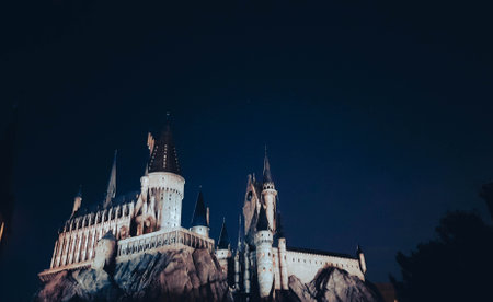 Osaka, Japan on July 8, 2019. A very beautiful light show at night at Hogwarts Castle that you must and must see when you visit Universal Studios Japan. Very tense and interesting.のeditorial素材