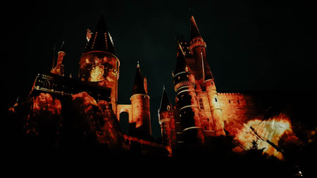 Osaka, Japan on July 8, 2019. A very beautiful light show at night at Hogwarts Castle featuring the four dormitories that you must see when you visit Universal Studios Japan.のeditorial素材