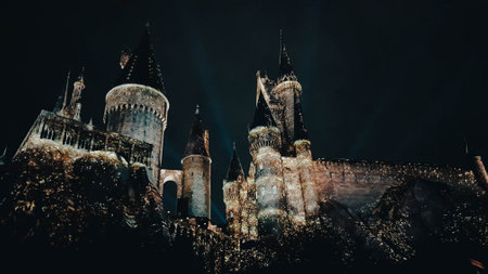 Osaka, Japan on July 8, 2019. A very beautiful light show at night at Hogwarts Castle featuring the four dormitories that you must see when you visit Universal Studios Japan.のeditorial素材