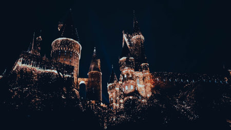 Osaka, Japan on July 8, 2019. A very beautiful light show at night at Hogwarts Castle featuring the four dormitories that you must see when you visit Universal Studios Japan.のeditorial素材
