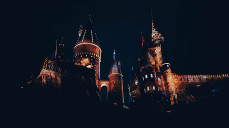 Osaka, Japan on July 8, 2019. A very beautiful light show at night at Hogwarts Castle featuring the four dormitories that you must see when you visit Universal Studios Japan.のeditorial素材