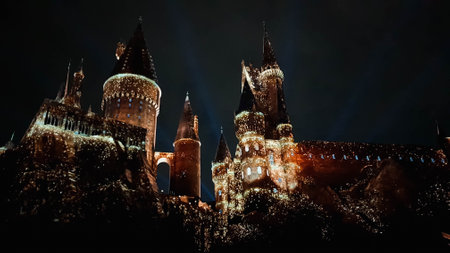 Osaka, Japan on July 8, 2019. A very beautiful light show at night at Hogwarts Castle featuring the four dormitories that you must see when you visit Universal Studios Japan.のeditorial素材