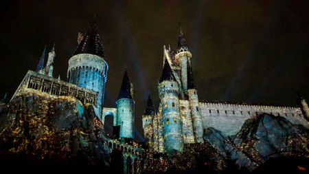 Osaka, Japan on July 8, 2019. A very beautiful light show at night at Hogwarts Castle featuring the four dormitories that you must see when you visit Universal Studios Japan.のeditorial素材
