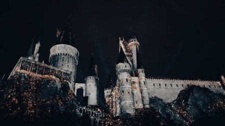 Osaka, Japan on July 8, 2019. A very beautiful light show at night at Hogwarts Castle featuring the four dormitories that you must see when you visit Universal Studios Japan.のeditorial素材