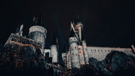 Osaka, Japan on July 8, 2019. A very beautiful light show at night at Hogwarts Castle featuring the four dormitories that you must see when you visit Universal Studios Japan.のeditorial素材