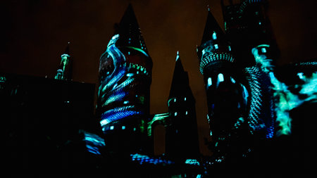 Osaka, Japan on July 8, 2019. A very beautiful light show at night at Hogwarts Castle featuring the four dormitories that you must see when you visit Universal Studios Japan.のeditorial素材