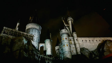 Osaka, Japan on July 8, 2019. A very beautiful light show at night at Hogwarts Castle that you must and must see when you visit Universal Studios Japan. Very tense and interesting.のeditorial素材