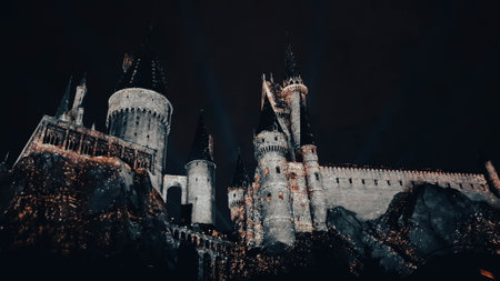 Osaka, Japan on July 8, 2019. A very beautiful light show at night at Hogwarts Castle featuring the four dormitories that you must see when you visit Universal Studios Japan.のeditorial素材